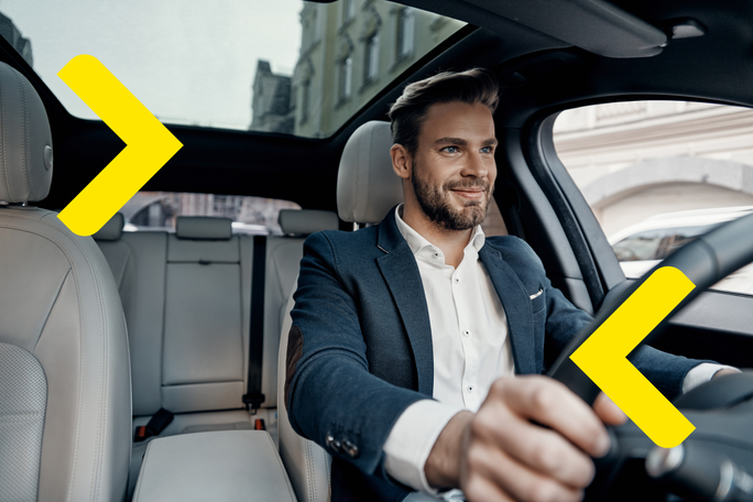 A young business man driving his new car bought from Raiffeisen Leasing